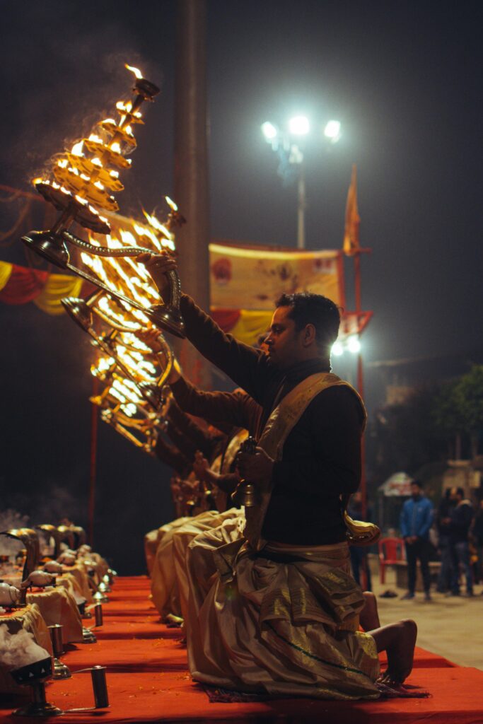 Capturing the mesmerizing Ganga Aarti ceremony at Varanasi with priests performing rituals by the river.